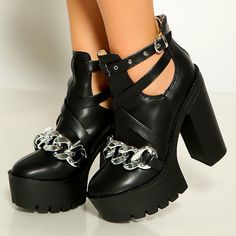 Step out in fierce style with these Black Platform Booties. Featuring chunky heels, cut-out details, and chain embellishments, these buckle ankle boots are a must-have for edgy fashion enthusiasts. Color: Black Heel Type: Chunky heel Heel Height: 4.72" / 120 mm approx Product measurements were taken using size 8. Please note that measurements may vary by size. Toe: Round toe With platform Metal chain embellishment Adjustable buckle strap design Back zipper closure Cut-out design Lug Sole design Handcrafted US sizing. Fits true to size. Edgy Chain Boots For Streetwear, Edgy Chunky Platform Boots For Party, Edgy Chunky Platform Ankle Boot Heels, Edgy Chunky High Heel Platform Boots, Punk Style Party Boots With Block Heel, Edgy Boots With Chain Strap And Round Toe, Trendy Party Platform Boots With Buckle Closure, Edgy Chunky Platform Heels, Edgy Platform Boots With Block Heel