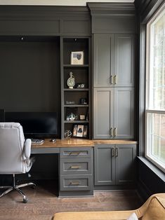 a home office with gray cabinets and white chair