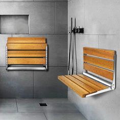 two wooden benches sitting next to each other in a room with gray walls and tile flooring