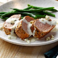 a white plate topped with meat and green beans