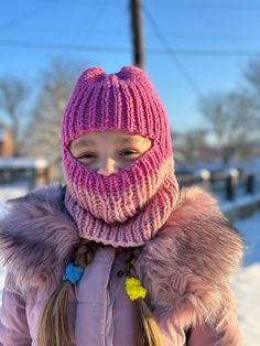 Keep your little one warm and stylish this winter with our knitted baby balaclava hat! This hat is made with soft, high-quality yarn and is available in a variety of colors. This hat is perfect for keeping your child's face and head warm in cold weather. The snug fit helps to seal out the cold, and the soft yarn is gentle on your child's skin. This hat is also a great fashion statement. The vibrant pink color is sure to turn heads. Handmade Yarn Knitting Pattern For Winter, Handmade Winter Knitting Pattern In Yarn, Handmade Balaclava For Winter Cold Weather, Handmade Balaclava For Winter, Handmade Winter Balaclava For Cold Weather, Hand Knitted One Size Balaclava For Winter, Handmade Balaclava For Cold Weather Winter, Handmade Winter Knitting Pattern One Size, Hand Knitted Balaclava For Winter Outdoors