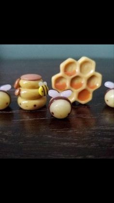 five honeybees are lined up next to each other on a wooden counter top