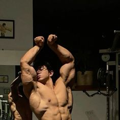 a man flexing his muscles in the gym