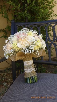 a bouquet of flowers sitting on top of a bench