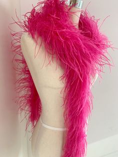 a mannequin wearing a pink feathered scarf