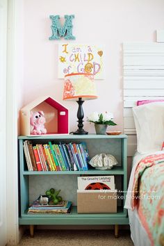 a child's bedroom with bookshelf and toys on the shelf next to the bed