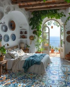 a bedroom with an arched doorway leading to the ocean and greenery on the walls