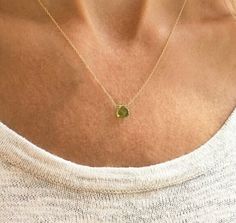 "This genuine peridot gemstone sits on a dainty and minimalist 14k gold filled, sterling silver, rose gold filled, or 14k gold chain. Subtle and simple, this beautiful semi-precious stone necklace is perfect by itself or for layering with other necklaces. Peridot is the August birthstone necklace and would make the perfect birthday gift. Available in many gemstones and birthstones in the drop down menu. Model is wearing the peridot necklace in 16\" gold filled. Jewelry is handmade by us in our NYC studio. We focus on craftsmanship and quality using only the highest quality materials and handpicked genuine gemstones.  PACKAGING We take pride in creating beautifully packaged orders. Jewelry arrives delicately wrapped in tissue and placed in a kraft box inside a logo drawstring pouch. Your pa Green Minimalist Gemstone Birthstone Necklace, Minimalist Peridot Birthstone Jewelry, Minimalist Gold Peridot Jewelry, Minimalist Green Peridot Jewelry, Dainty Peridot Jewelry, August Birthstone Necklace, Peridot Birthstone, Nyc Studio, Peridot Necklace