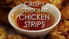 crispy coconut chicken strips with ketchup in a small white bowl on top