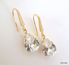 "These romantic earrings have clear Austrian teardrop crystals. . Hooks ear wires are nickel free gold plated over 92.5 sterling silver over brass.  They have small cubic zirconia set in. Earrings are approximately 1 1/4\" long from top to bottom. Crystal measures 1/2\" by 3/8\" at its widest point or 14 x 10 mm. They make a great gift for someone special, bridesmaid, maid of honor, mother of the bride, mother of the groom, or just simply to spoil yourself!" White Sparkling Teardrop Earrings, Classic Sparkling Teardrop Crystal Earrings, White Crystal Teardrop Earrings, White Teardrop Earrings With Sparkling Stones, White Sparkling Teardrop Chandelier Earrings, Teardrop Crystal Wedding Earrings With Ear Wire, Teardrop Crystal Ear Wire Earrings For Wedding, Sparkling Teardrop Chandelier Earrings For Gifts, Sparkling Teardrop Chandelier Earrings As Gift