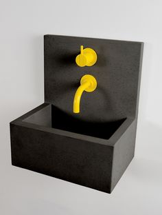 a black box with yellow handles on it