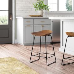 two stools sitting in front of a kitchen counter