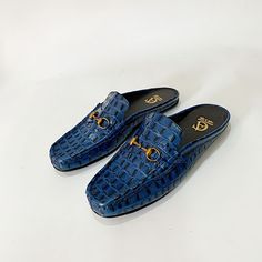 "Elevate your attire with our Men's Navy Blue Crocodile Leather Skin Half Shoes. Crafted from genuine crocodile leather, these shoes exude luxury and style. The rich navy blue hue adds a touch of sophistication, perfectly complementing traditional African outfits. With their half shoe design, they offer both comfort and elegance, making them the ideal choice for any special occasion. Step into tradition with these exquisite shoes that blend timeless craftsmanship with cultural authenticity." Luxury Blue Mules, Luxury Blue Slip-on Loafers, Luxury Crocodile Pattern Slip-on Loafers, Luxury Blue Leather Mules, Blue Leather Sole Slip-on Mules, Blue Slip-on Mules With Leather Sole, Half Shoe, Half Shoes, African Outfits