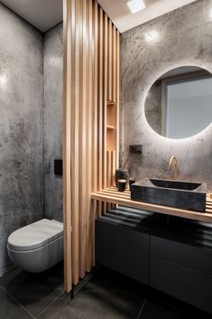 a bathroom with a sink, mirror and toilet in the corner next to a wooden shelf