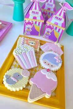 some cookies are sitting on a tray next to other treats and candy boxes with decorations