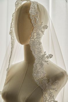 a mannequin with a veil on top of it