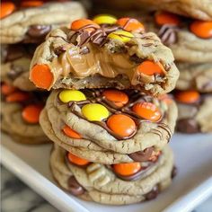 cookies with candy on top and chocolate chips in the middle are stacked up to look like reese's