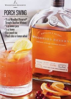 a bottle of woodford reserve punch sitting next to a glass filled with orange slices