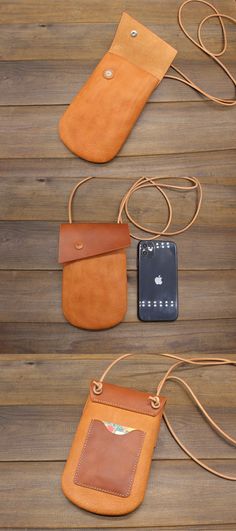 three different types of cell phones are laid out on a wooden surface, one has a leather case and the other has a cord