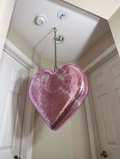 a pink heart shaped light hanging from the ceiling