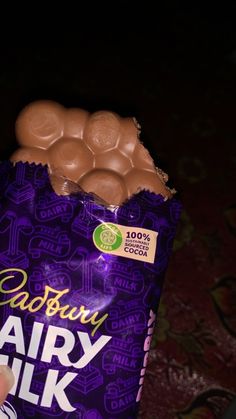 someone holding a bag of cadbury dairy milk eggs