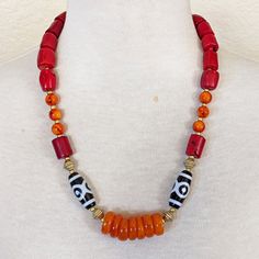 Materials: Red Coral Bamboo Barrel Beads, Burnt Orange Resin Rondelles, Orange And Red Swirl Glass Beads, Acrylic Black And White Ethnic Print Accent Beads, African Brass Bicones, Small Gold Glass Spacers, Gold Plated Lobster Clasp. Length: Approximately 23" And 2" Extender Chain Statement Necklace Boho Necklace Rustic Necklace Southwestern Orange Beaded Necklaces With Round Beads, Southwestern Style Necklaces With Large Beads, Artisan Red Beaded Necklace With Round Beads, Southwestern Orange Beaded Necklace With Round Beads, Artisan Red Beaded Necklace, Red Wooden Beads For Festivals, Artisan Red Necklaces With Colorful Beads, Artisan Red Necklace With Colorful Beads, Artisan Red Beads For Festival