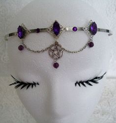 This beautiful circlet has three sterling silver plated filigree accents with purple faceted glass settings, purple faceted bead drops, rhinestones, pewter silver pentacle and metal chain. Adjustable. Gothic Purple Metal Jewelry, Adjustable Fantasy Jewelry For Festivals, Silver Fantasy Jewelry For Festivals, Adjustable Fantasy Festival Jewelry, Adjustable Silver Gothic Body Jewelry, Adjustable Gothic Jewelry For Festivals, Silver Fantasy Costume Jewelry, Gothic Adjustable Body Jewelry For Festivals, Nickel-free Fantasy Jewelry For Festivals