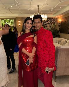 a man and woman dressed in red posing for the camera