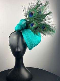 Teal abaca silk swirl with peacock eyes. Sits on a comfortable black headband. Lightweight and easy to wear. Ships in a high quality storage box. One of a kind.  Perfect for Kentucky Derby, Royal Ascot, church, weddings, just for fun.  this is a raw edge material and some fraying is to be expected Peacock Eyes, Easter Bonnets, Church Weddings, Easter Bonnet, Head Pieces, Black Headband, Royal Ascot, Peacock Feathers, Fascinator Hats