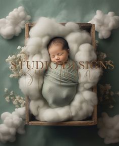 a newborn baby wrapped in a blanket is surrounded by fluffy clouds and cotton floss