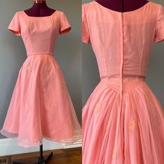 "Vintage 1950s coral pink cocktail party dress, with aaalllll the party in the back. A round neckline and waist in front, with piping detail and rose appliques. Soft floaty organza over a taffeta base. This dress boasts a GORGEOUS Basque waist with pleated detail in the back, with a dropped back neck. There is a metal Star zipper, and several hooks. Someone has sewn a stiff tulle crinoline into the dress by hand, and I have chosen to leave it as is. The crinoline hooks at the back, and gives great volume to the dress. The outer organza layer also has horse hair (a stiffening sewing strip, not animal product) onto the bottom hem for volume. Condition: excellent vintage condition. Some seam strain is seen on the back waist, but fairly minor. See last pic. Labels/tags:   Measurements: taken f 1950s Style Pink Vintage Dress For Party, 1950s Style Pink Vintage Party Dress, 1950s Style Pink Party Vintage Dress, Vintage Pink Dress With Fitted Bodice For Party, Pink Vintage Dress With Fitted Bodice For Party, Fitted Pink Vintage Prom Dress, 1950s Pink Vintage Wedding Dress, 1950s Style Pink Wedding Dress, Basque Waist Dress