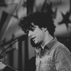 black and white photograph of a man singing into a microphone