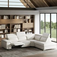 a living room with a white couch and book shelves