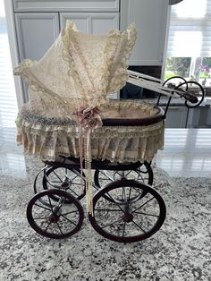 a baby carriage with an umbrella attached to it