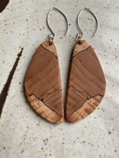 Earrings by juried Kentucky Crafted artist Wesley Page.  Wesley carefully selects each piece of wood for character and color.  All earrings are expertly and artistically matched by grain pattern, which is a fine, skilled art.   All earrings are: * Made with Kentucky hardwoods * Lightweight and of high quality * Set in Argentium silver * Finished with our natural recipe using local beeswax Handmade Wood Drop Earrings, Handmade Wooden Drop Earrings, Artisan Wood Handmade Earrings, Handmade Artisan Wood Earrings, Artisan Brown Wooden Earrings, Artisan Brown Wood Earrings, Unique Natural Wood Earrings, Unique Brown Wooden Earrings, Natural Wood Jewelry With Variations