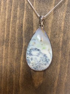 "Blue, grey and green Indonesian Dendritic Agate cabochon. $60 on silver chain. $50 for cabochon only Cabochon: 1.7\" Shown on 22\" chain." Silver Drop Necklace With Cabochon, Moss Agate Cabochon Pendant Jewelry, Silver Moss Agate Cabochon Jewelry, Silver Moss Agate Jewelry With Cabochon, Moss Agate Cabochon Pendant Necklace, Moss Agate Cabochon Necklace For Gift, Grey And Green, Agate Cabochon, Crystal Necklaces