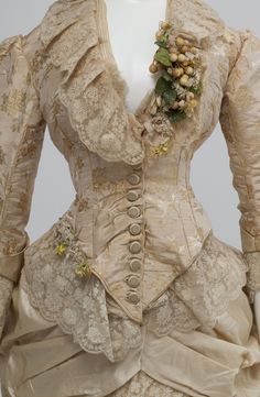 Wedding dress in three pieces, bodice, skirt and train. The bodice is of beige ribbed silk brocaded in yellow and white. There are lace ruffles at the neck, sleeves and waist and the front fastens with 11 covered buttons and buttonholes. A small bouquet of orange blossom decorates the left front. Th... My Lady Jane Wedding Dress, Russian Wedding Dress, Vintage Weddingdress, Elizabeth Jane, Vintage Attire, 1880s Fashion, Bustle Dress, New South Wales Australia, Elegant Attire