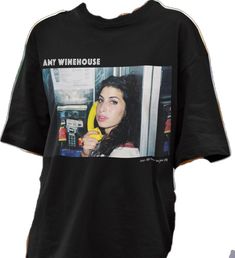 a black shirt with an image of a woman holding a banana