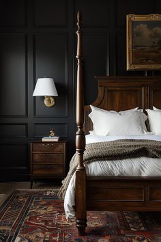 a bedroom with black walls and white bedding