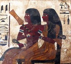 an egyptian painting on the back of a couch with two women sitting next to each other