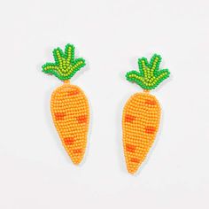 two beaded carrots with green leaves on them, one is yellow and the other is orange