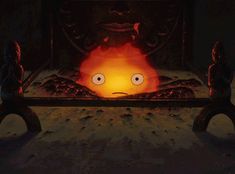 a fire burning in a fireplace with faces drawn on it's face and eyes