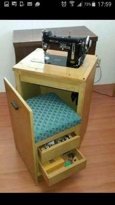 a sewing machine sitting on top of a wooden cabinet