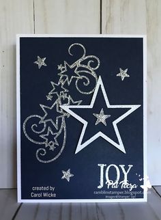 a handmade christmas card with the word joy written in white and silver stars on it