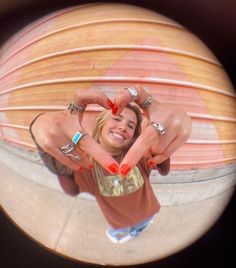 a woman making a heart shape with her hands