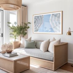 a living room filled with furniture and a painting on the wall above it's windows