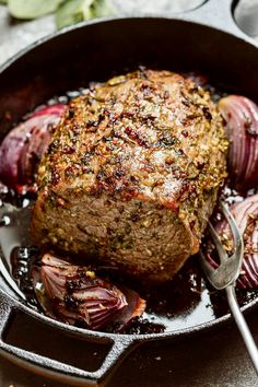 a steak in a skillet with onions on the side