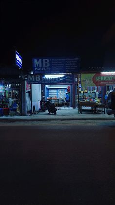 a motorcycle parked in front of a store at night