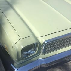 the front end of an old green car