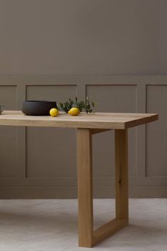 a wooden table with two lemons on it